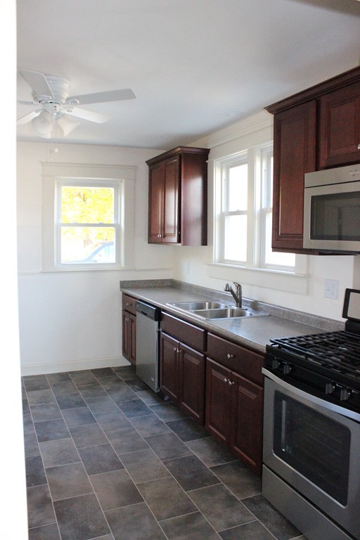 463 Boston Road Billerica, MA 01821 - Photo 9 of 19 a kitchen with a sink stove top oven and microwave