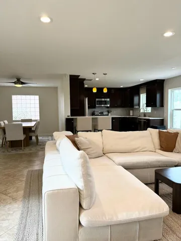 a living room with furniture and kitchen view