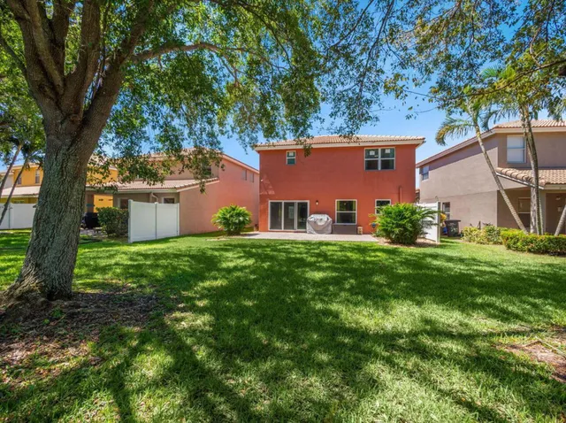 a front view of house with yard and trees