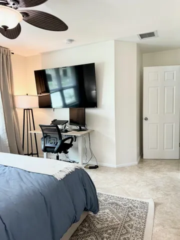 a bedroom with a bed and a flat screen tv