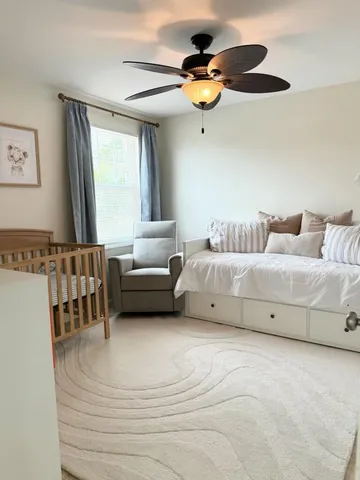 a bedroom with furniture and a large window