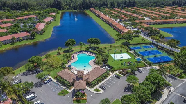 a dining room with furniture and large windows