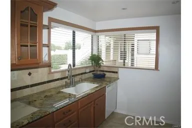 a kitchen with granite countertop a sink and a window