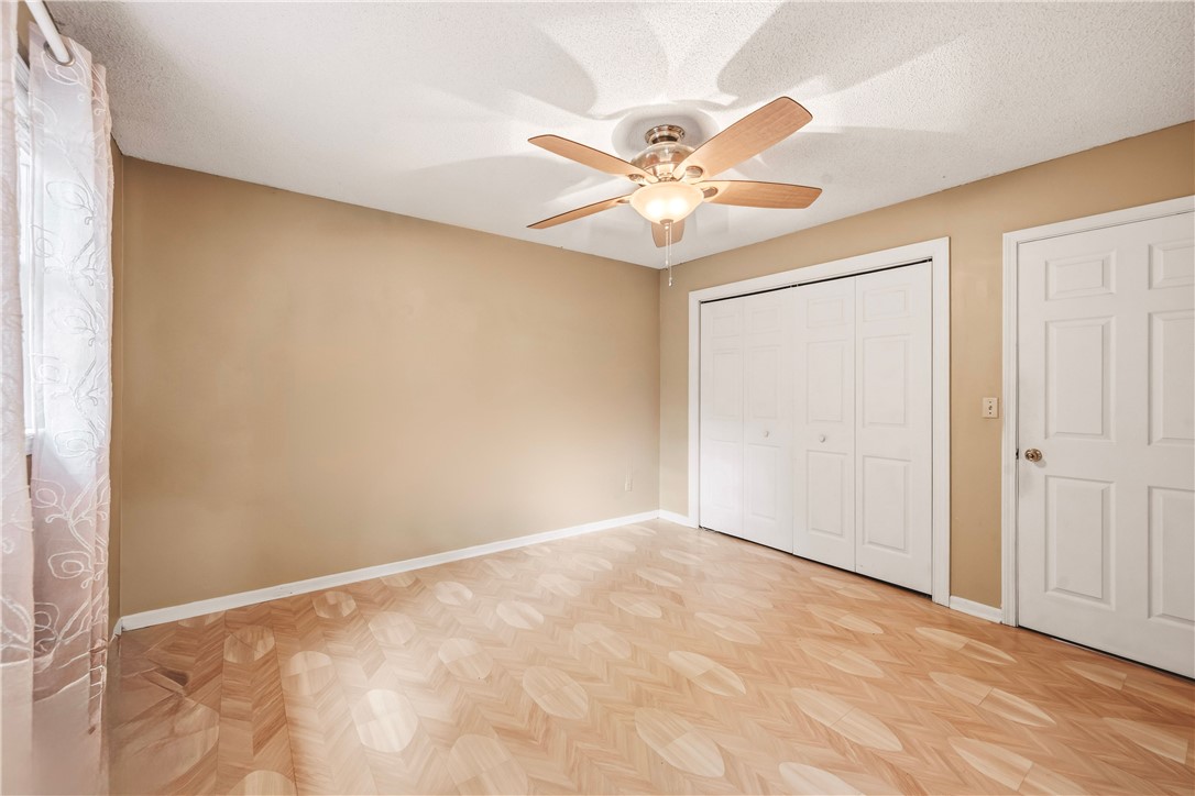 2001 Ridgeview Lane Seneca, SC 29678 - Photo 13 of 27 A well-lit bedroom with neutral walls, ample storage, and distinctive patterned flooring.