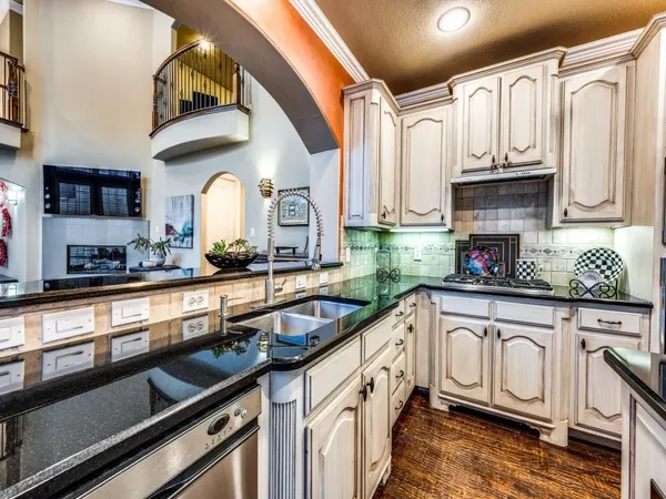 a kitchen with stainless steel appliances granite countertop a sink and cabinets