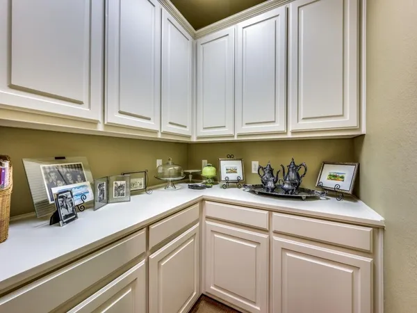 a kitchen with granite countertop white cabinets and sink