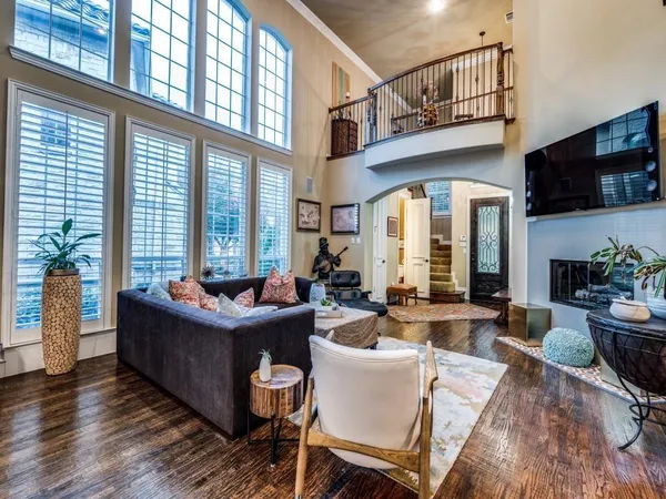 a living room with fireplace furniture and a large window