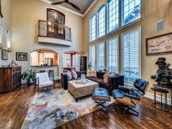 a living room with furniture fireplace and a large window