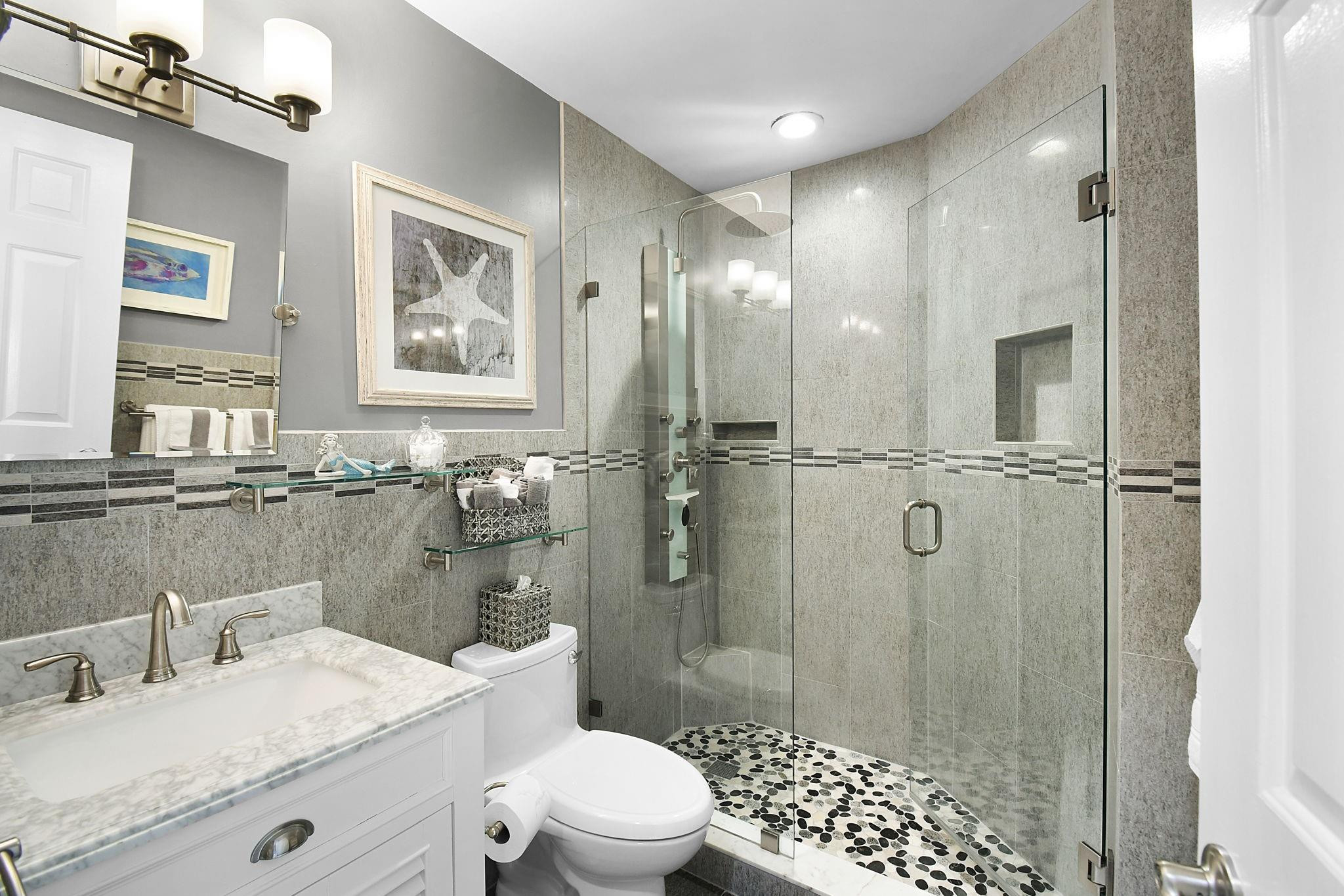 6040 Southeast Martinique Drive, Unit 201 Stuart, FL 34997 - Photo 33 of 63 EXQUISITE GUEST BATHROOM
