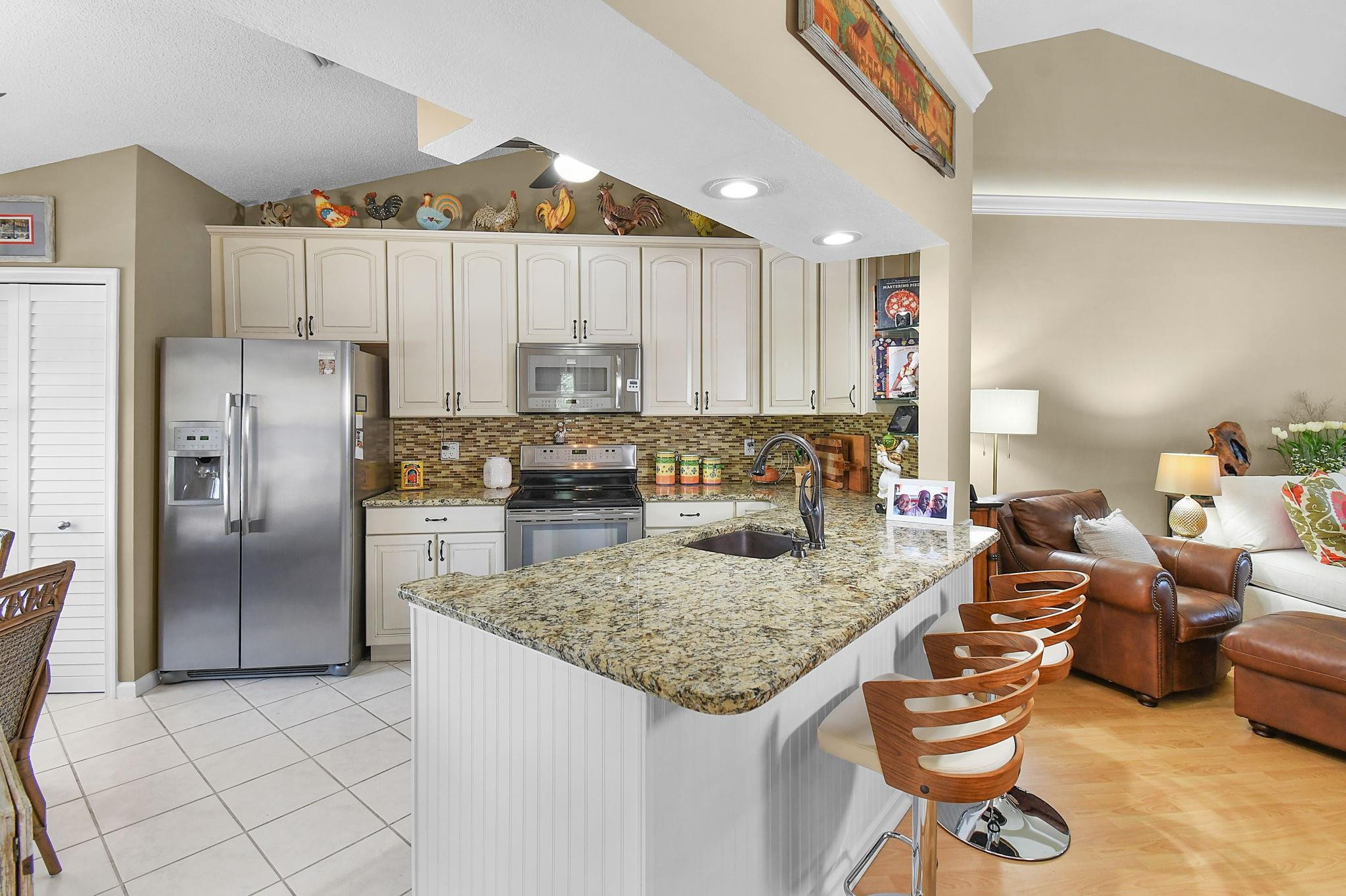 6040 Southeast Martinique Drive, Unit 201 Stuart, FL 34997 - Photo 4 of 63 BRIGHT KITCHEN OPEN TO LIVING AREA