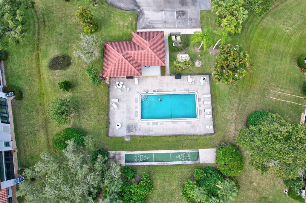 6040 Southeast Martinique Drive, Unit 201 Stuart, FL 34997 - Photo 62 of 63 COMMUNITY POOL AND SHUFFLE BOARD