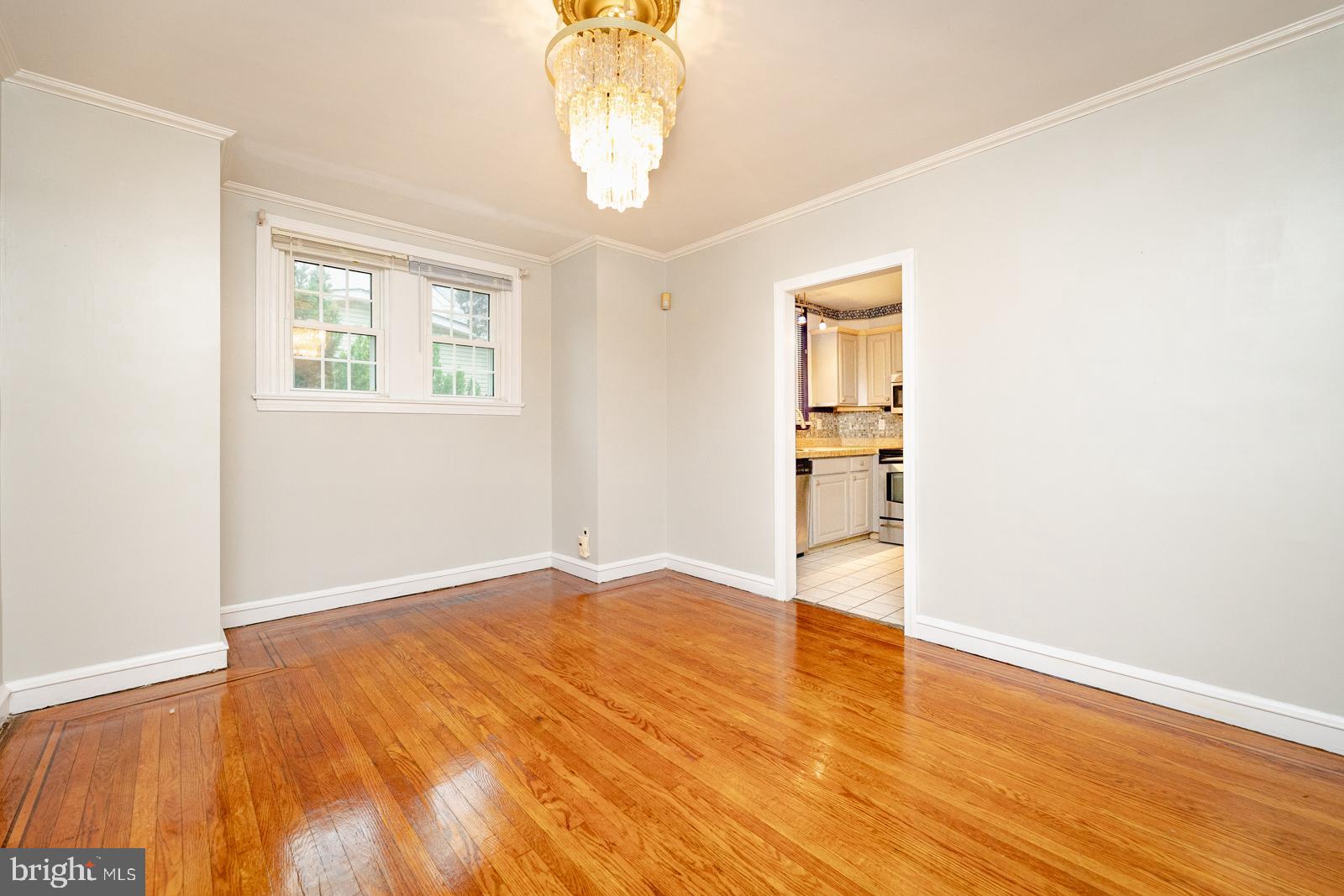 637 Croyden Road Cheltenham, PA 19012 - Photo 15 of 48 an empty room with wooden floor chandelier and windows