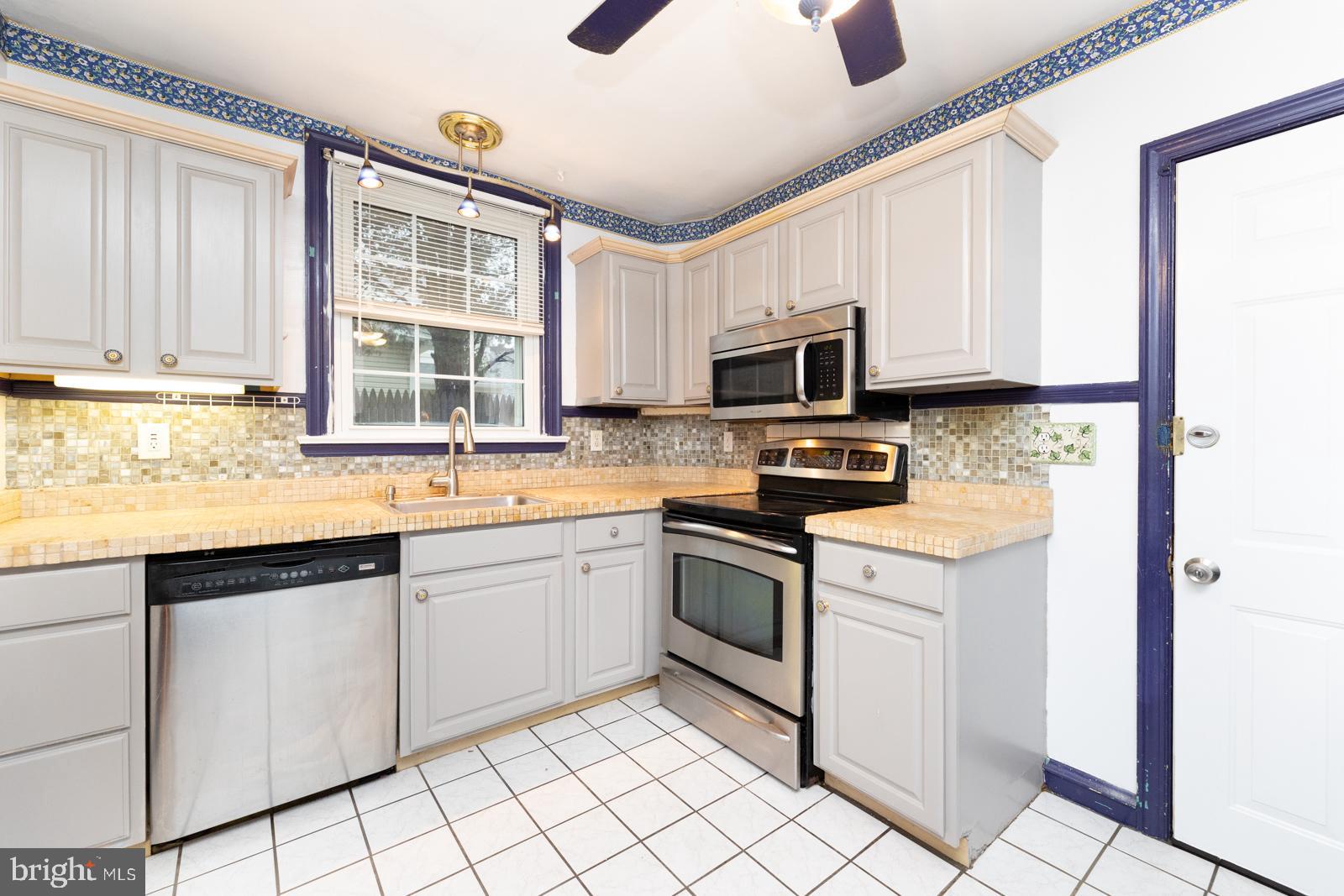 637 Croyden Road Cheltenham, PA 19012 - Photo 22 of 48 a kitchen with granite countertop a sink stainless steel appliances and cabinets