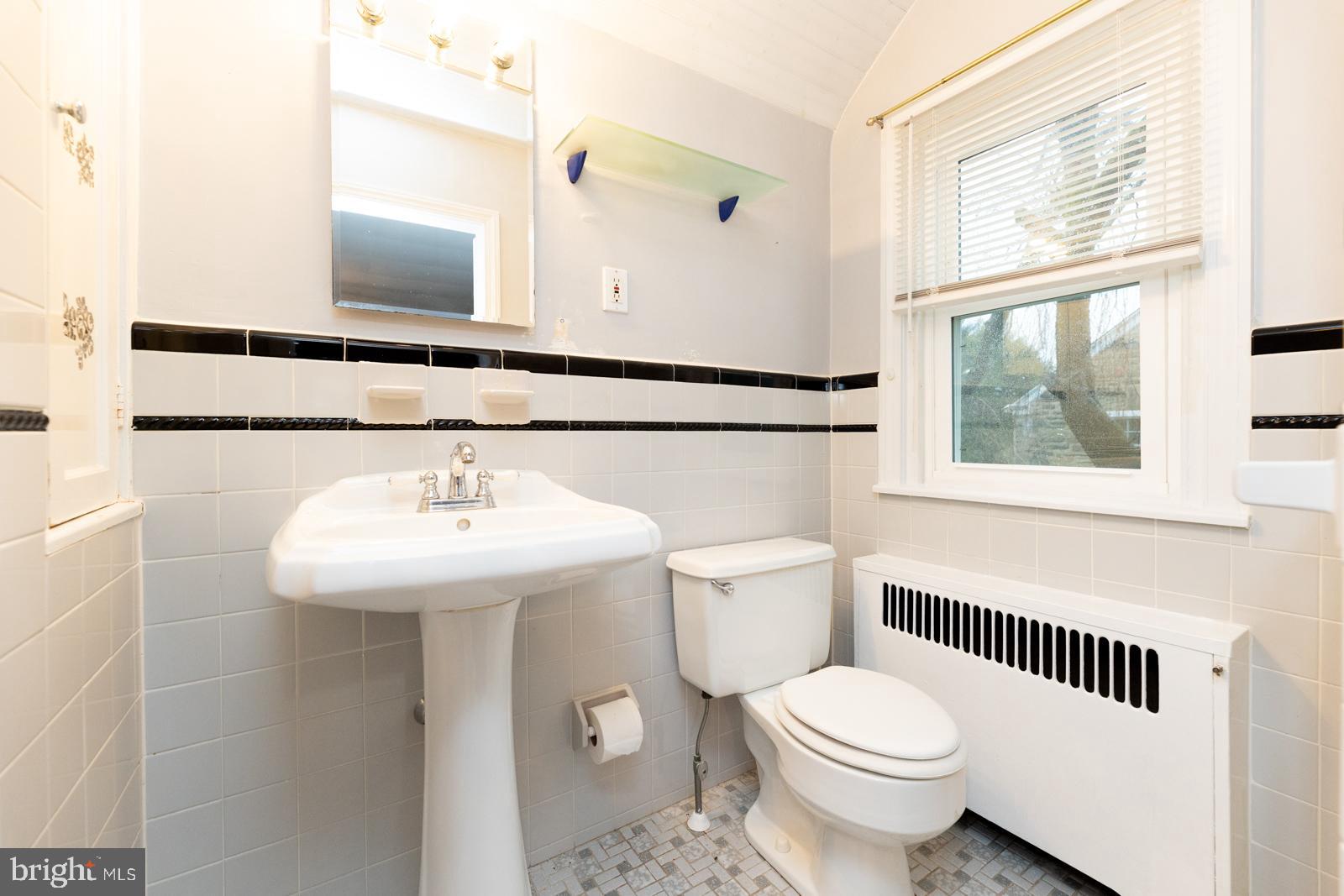637 Croyden Road Cheltenham, PA 19012 - Photo 35 of 48 a bathroom with a sink a toilet and a mirror