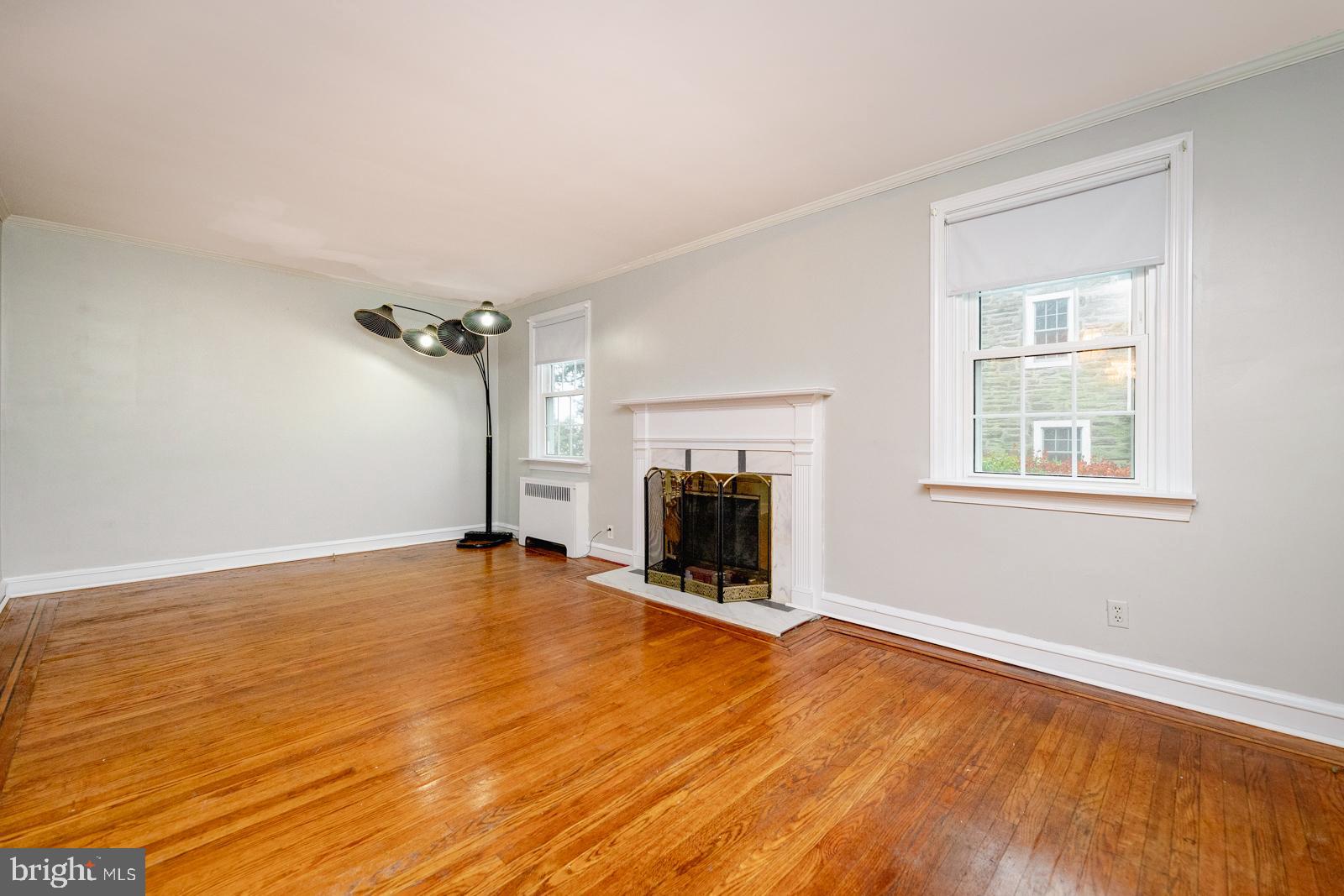 637 Croyden Road Cheltenham, PA 19012 - Photo 8 of 48 wooden view of an empty room with a fireplace and a window