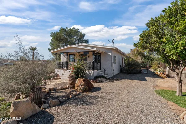 a view of a house with backyard and sitting area