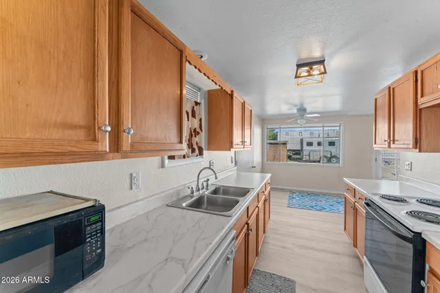 a kitchen with a sink stove top oven and cabinets