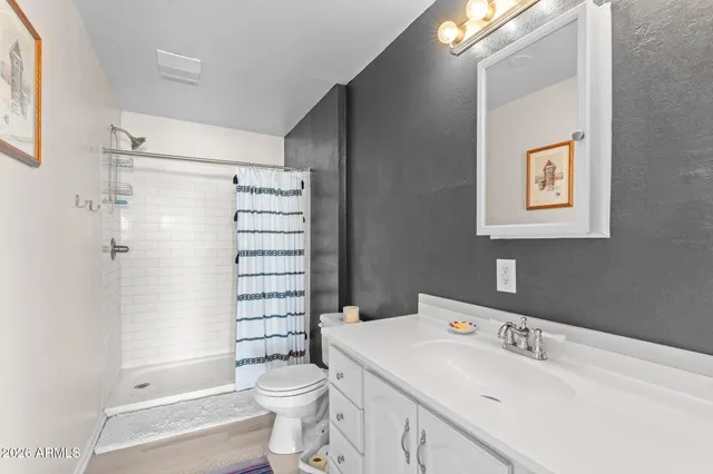 a bathroom with a sink toilet and shower