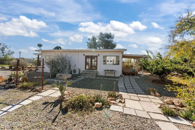 a view of a patio with table and chairs and potted plants