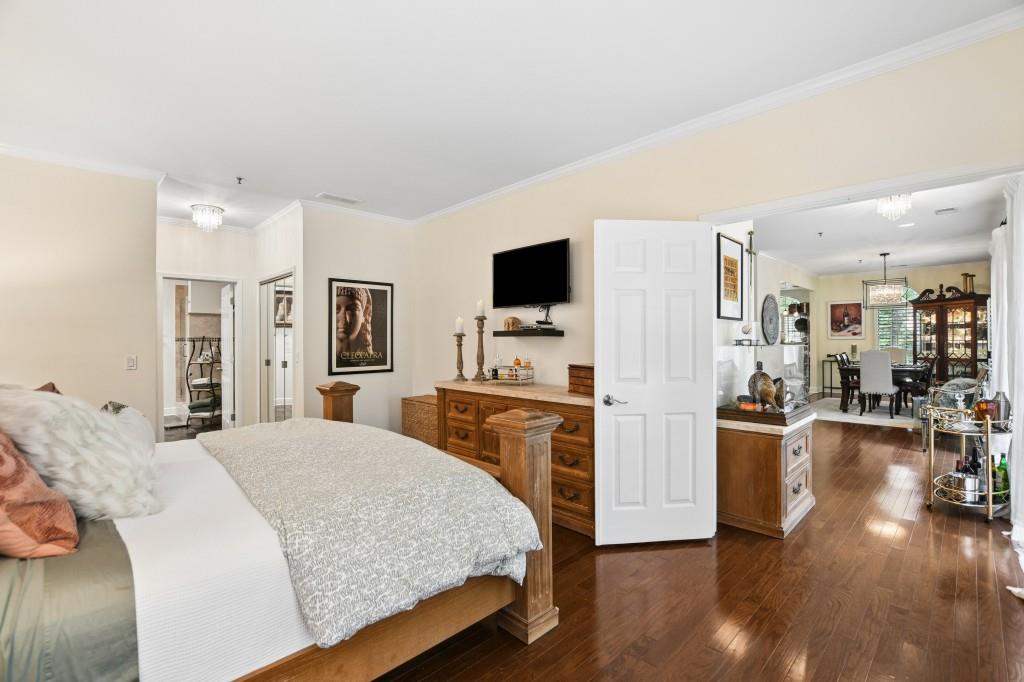 2921 Lenox Road Northeast, Unit 103 Atlanta, GA 30324 - Photo 20 of 37 a spacious bedroom with a bed and a flat screen tv