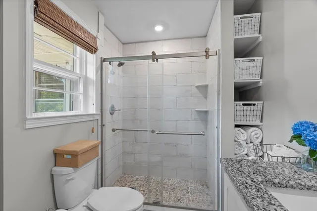 a bathroom with a toilet and shower