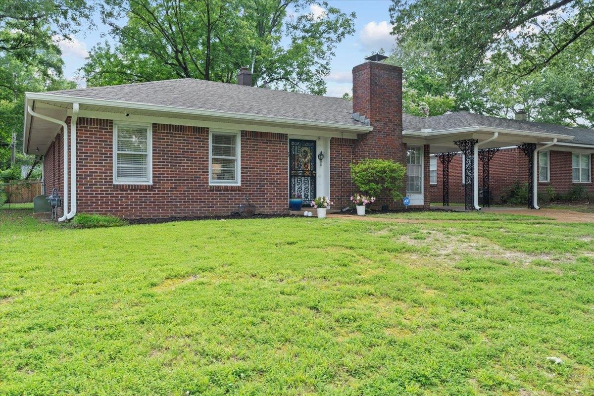 4491 Garnett Road Memphis, TN 38117 - Photo 2 of 32 a front view of a house with a yard and garage