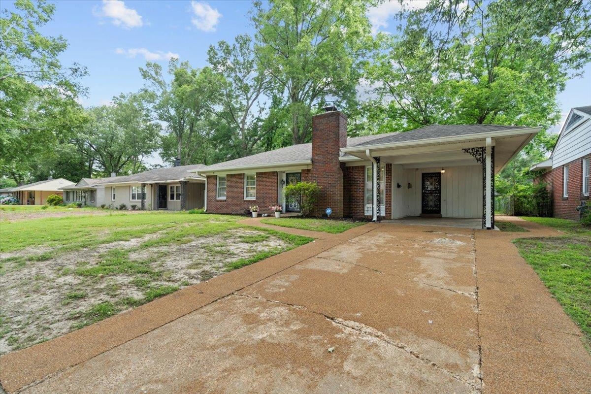 4491 Garnett Road Memphis, TN 38117 - Photo 26 of 32 a view of a house with a yard and large tree
