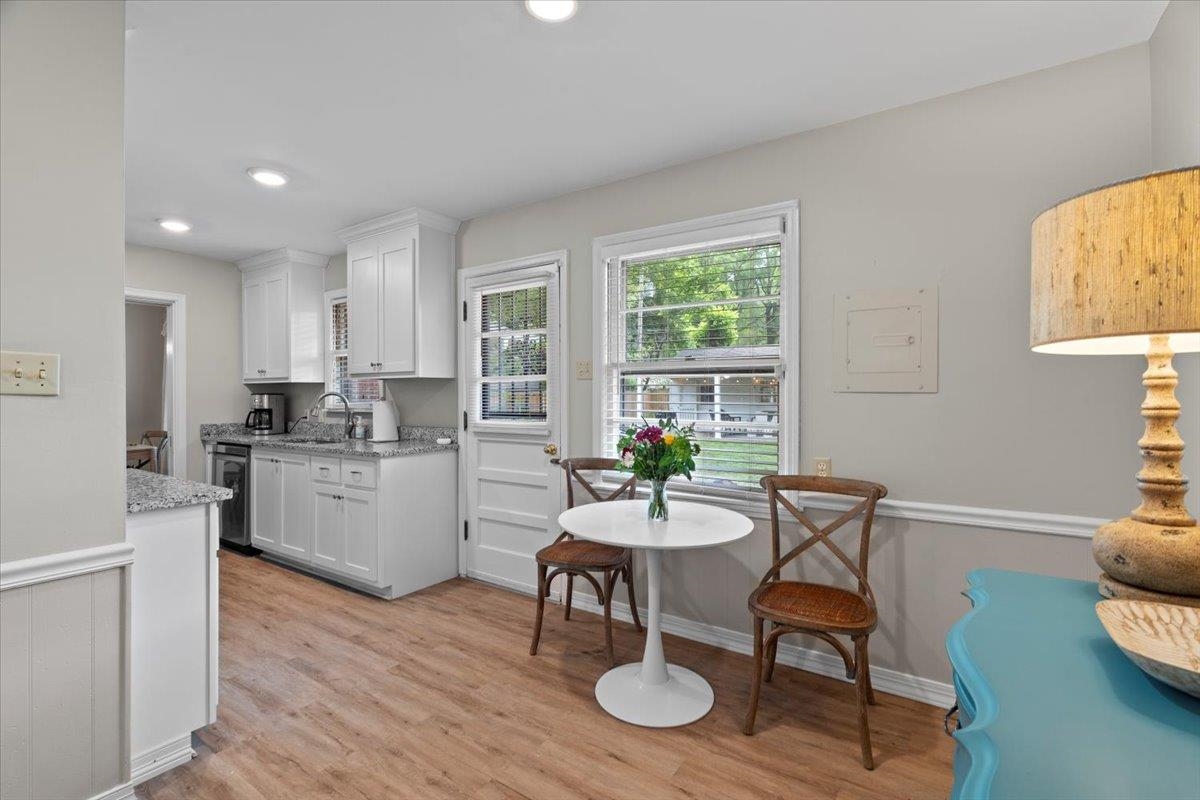 4491 Garnett Road Memphis, TN 38117 - Photo 8 of 32 a kitchen with a dining table chairs and microwave