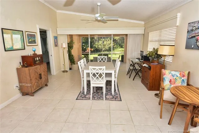 a dining room with furniture a chandelier and window