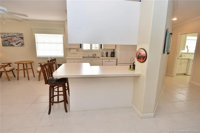 a kitchen with a table chairs and a refrigerator