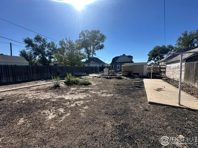 a view of a backyard with furniture and a fire pit