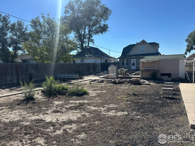 a view of a patio with a table chairs and a fire pit