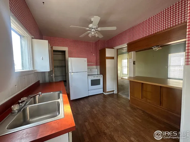 a kitchen with kitchen island a counter top space appliances and a window