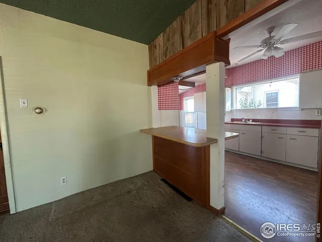 a room with stainless steel appliances wooden floor and a window
