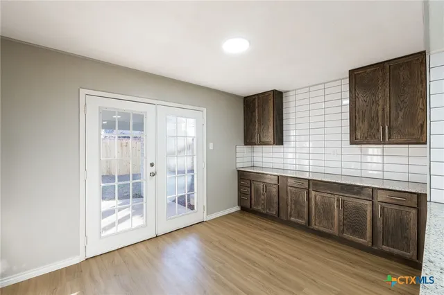 a view of kitchen with cabinets and wooden floor