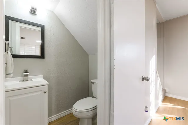 an empty room with window and ceiling fan