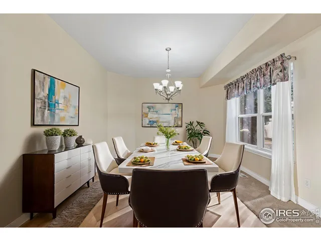 a view of a dining room with furniture and chandelier