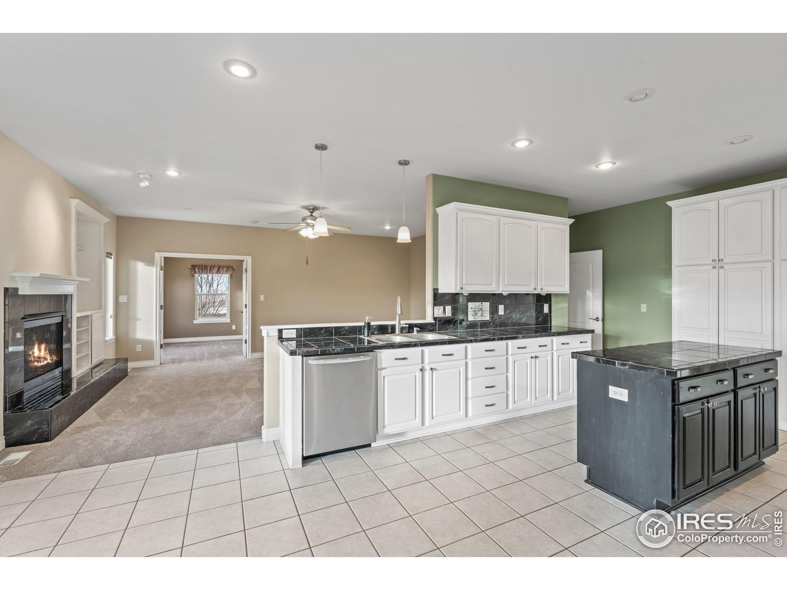 17035 Herring Road Colorado Springs, CO 80908 - Photo 13 of 38 a large kitchen with stainless steel appliances granite countertop a stove a sink and a refrigerator