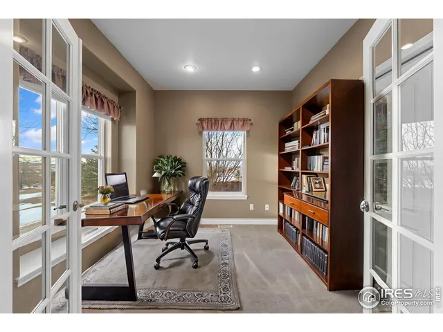 a workspace with furniture and a book shelf