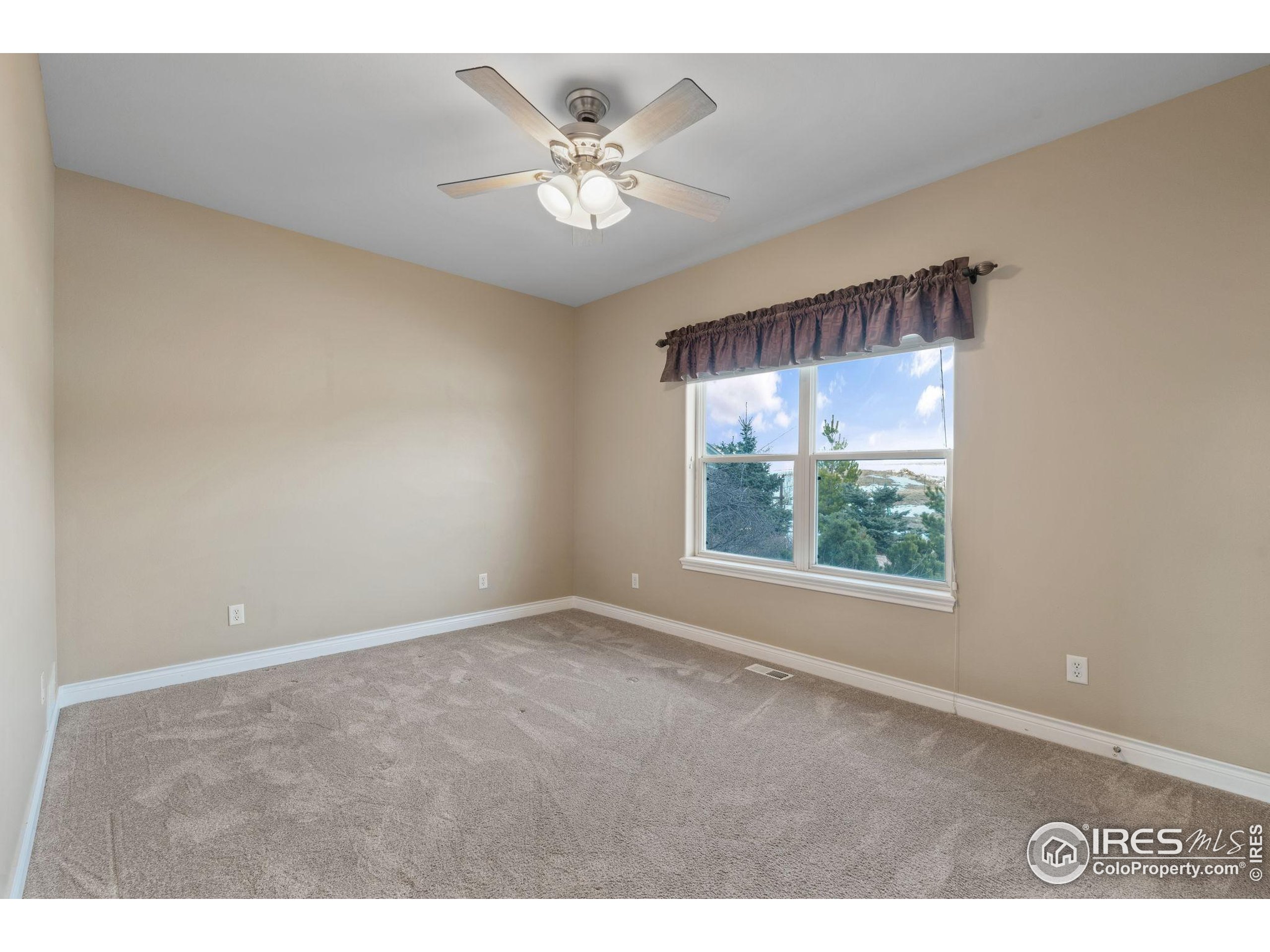 17035 Herring Road Colorado Springs, CO 80908 - Photo 27 of 38 a view of an empty room with a window