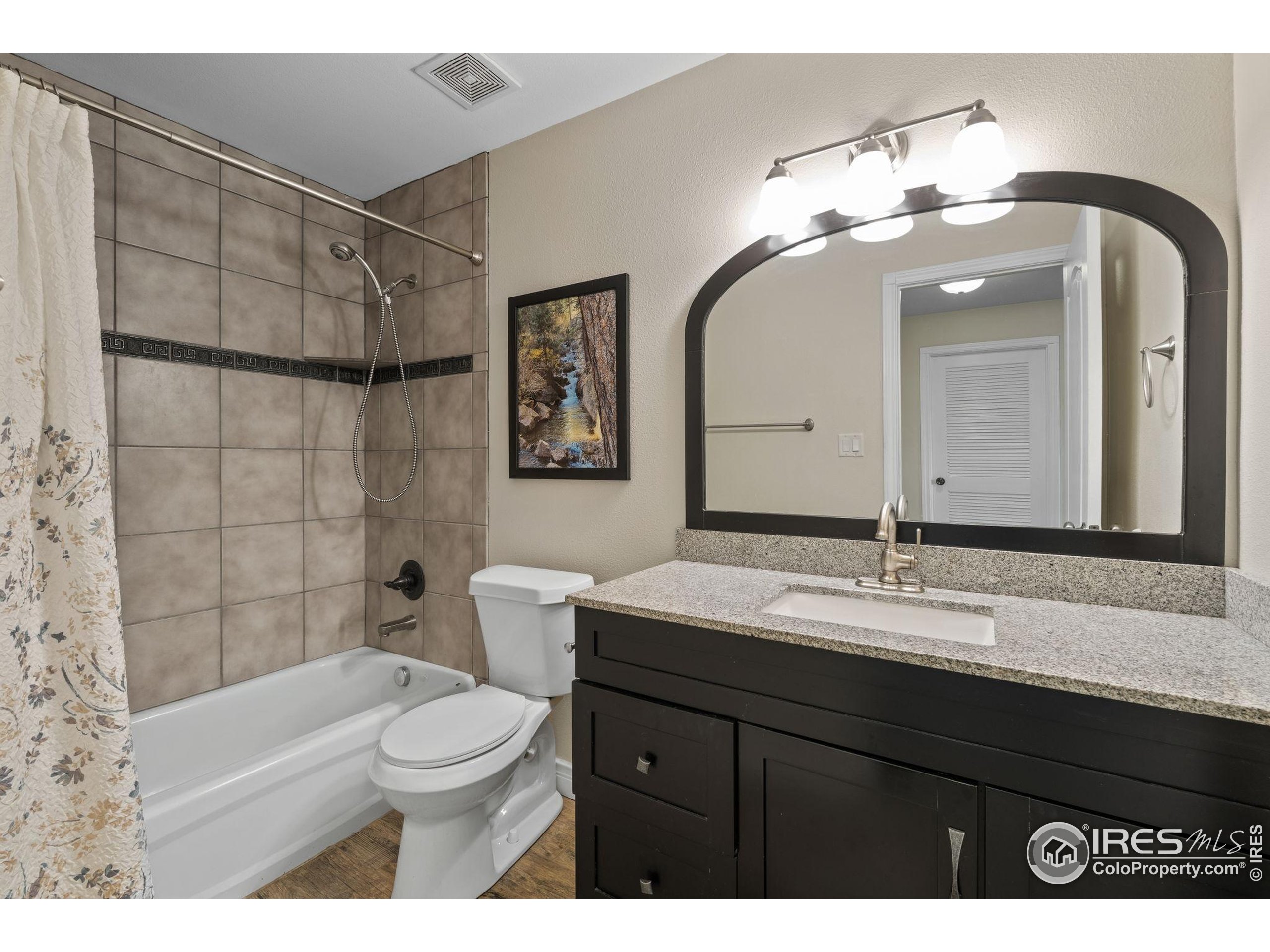 17035 Herring Road Colorado Springs, CO 80908 - Photo 38 of 38 a bathroom with a toilet a sink and mirror