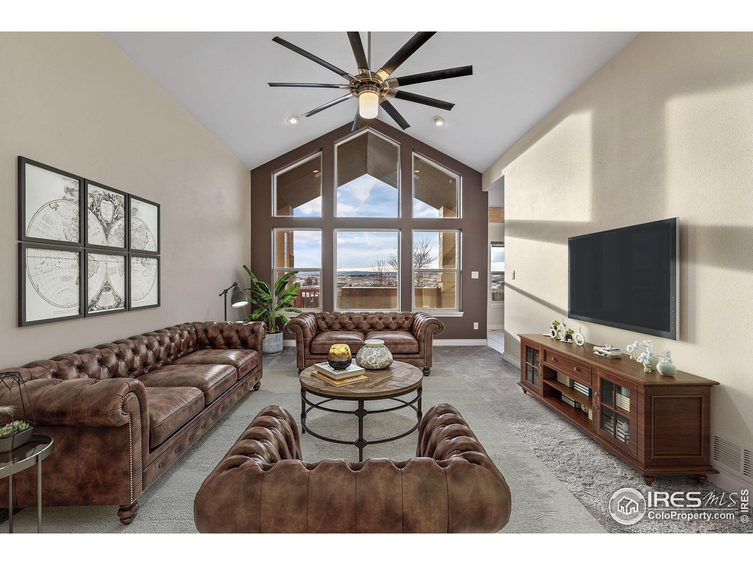 17035 Herring Road Colorado Springs, CO 80908 - Photo 8 of 38 a living room with furniture and a flat screen tv