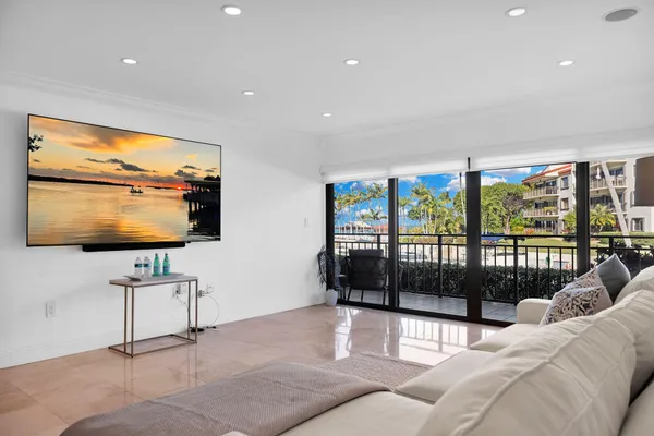 a living room with furniture a large window and a flat screen tv
