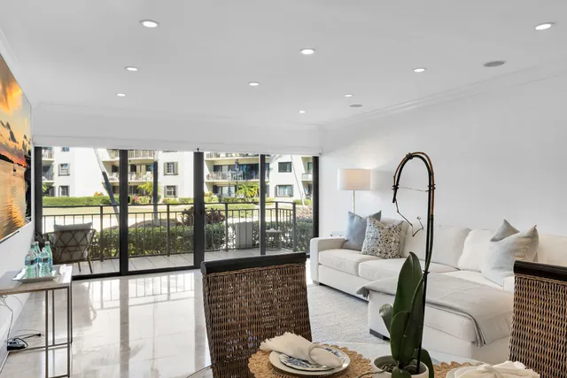 a living room with furniture a window and a dining table