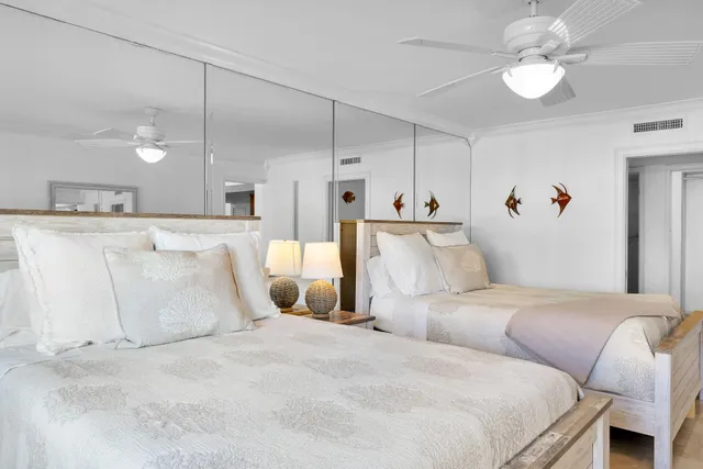 a bathroom with a double vanity sink a toilet and a mirror