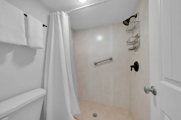 a bedroom with a bed and chandelier