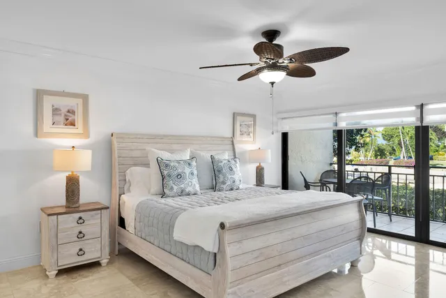 a view of building with yard and potted plants