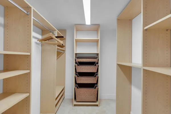 a front view of a house with a yard and potted plants