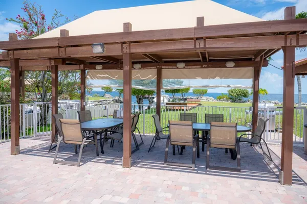 a view of backyard with outdoor seating and trees