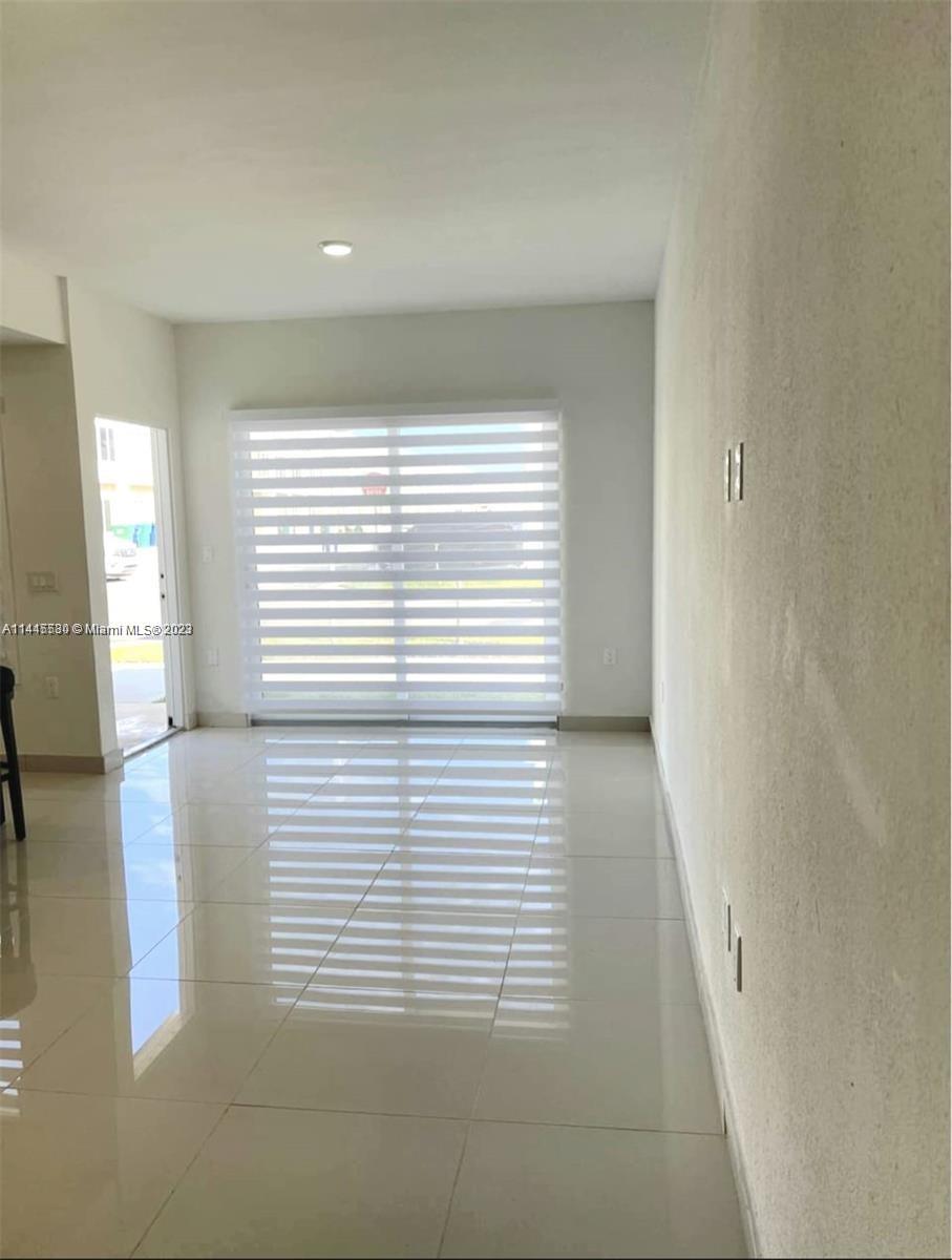 13966 Southwest 258th Street, Unit 13966 Homestead, FL 33032 - Photo 3 of 5 a view of a room that has a window in it